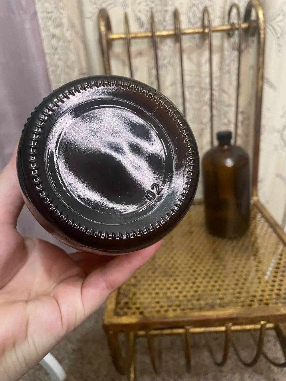 two amber glass Boston round bottles with black caps